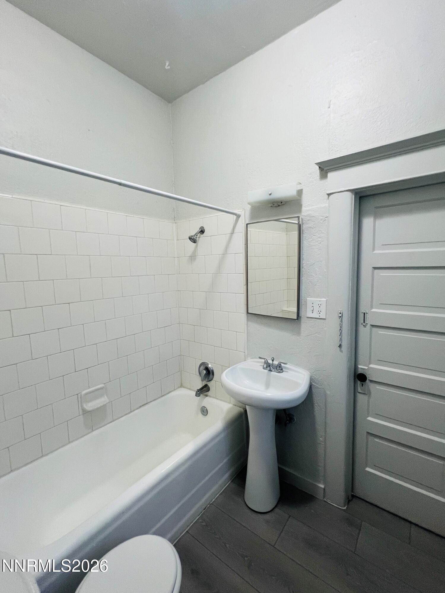 330 Stewart Street Reno, NV 89502 - Photo 6 of 21 a bathroom with a sink mirror toilet and bathtub