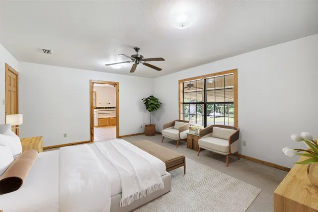 a bedroom with a bed couch and window