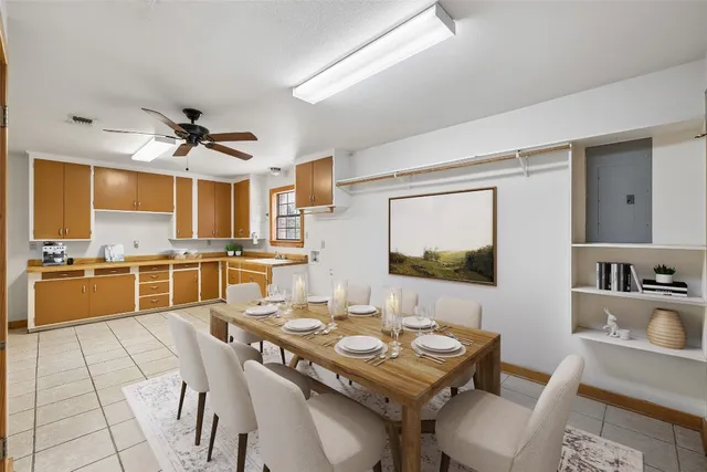 a kitchen with a table chairs stove and kitchen view