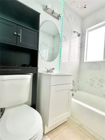 a bathroom with a toilet a sink and bathtub