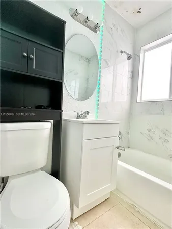 a bathroom with a toilet a sink and bathtub
