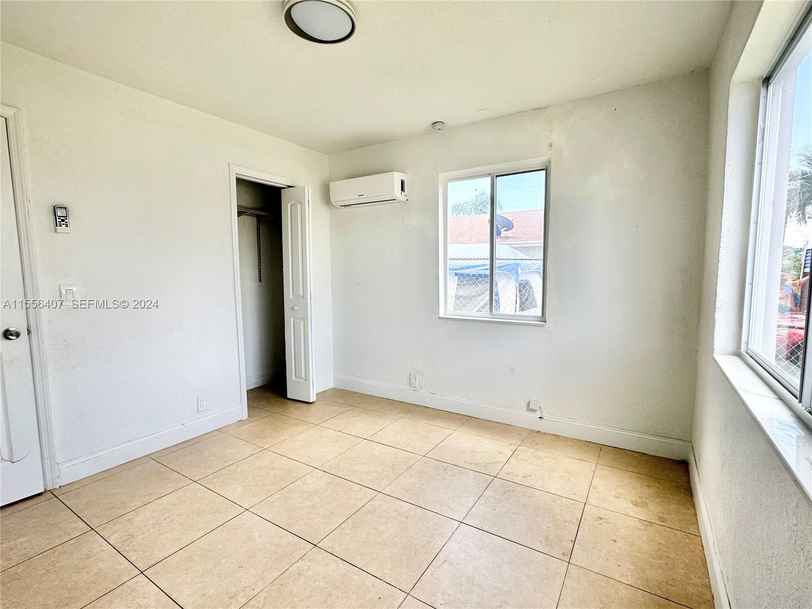 3730 S Avenue South, Unit 1 Riviera Beach, FL 33404 - Photo 9 of 12 an empty room with windows