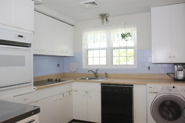 19 Cherry Road Framingham, MA 01701 - Photo 9 of 23 a kitchen with a sink stove and cabinets