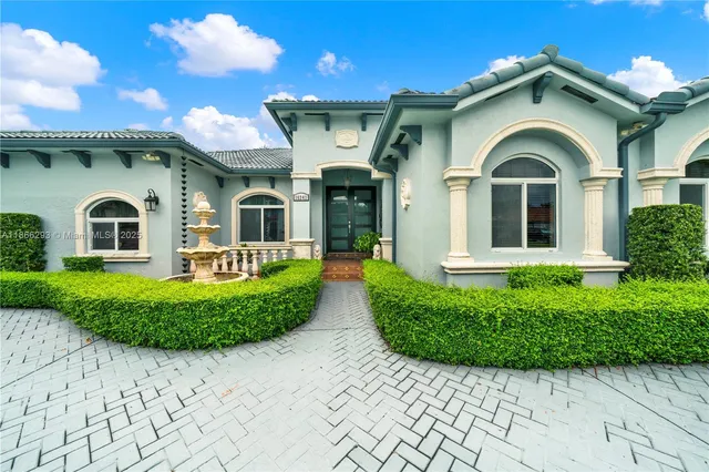 a front view of a house with a garden