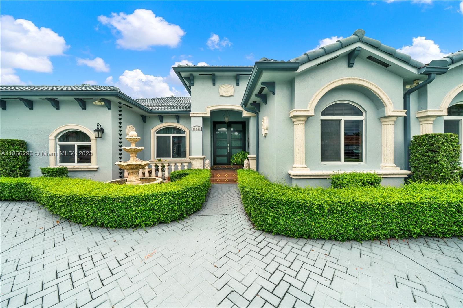 a front view of a house with a garden