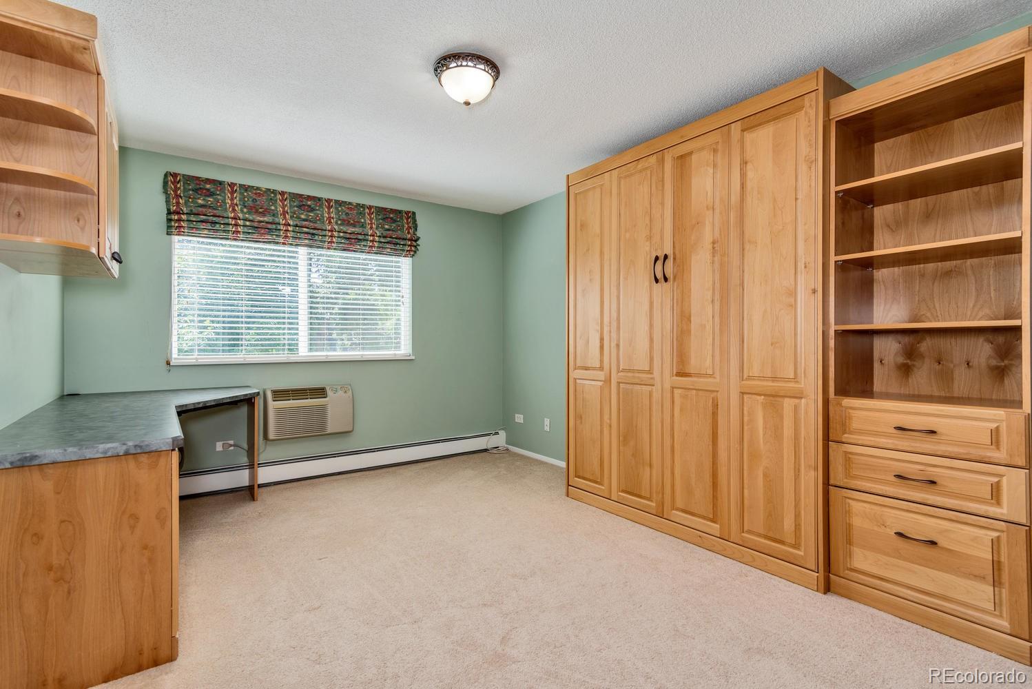 9155 Center Avenue, Unit 9B Denver, CO 80247 - Photo 11 of 35 an empty room with cabinet and windows