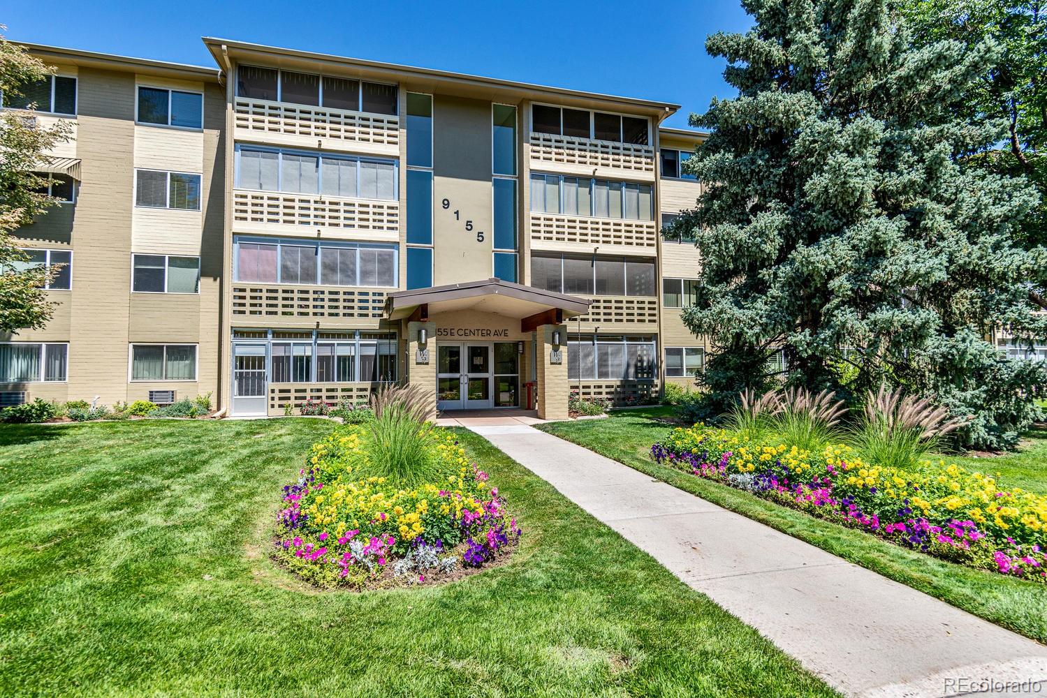 9155 Center Avenue, Unit 9B Denver, CO 80247 - Photo 16 of 35 a view of a house that has a flower garden