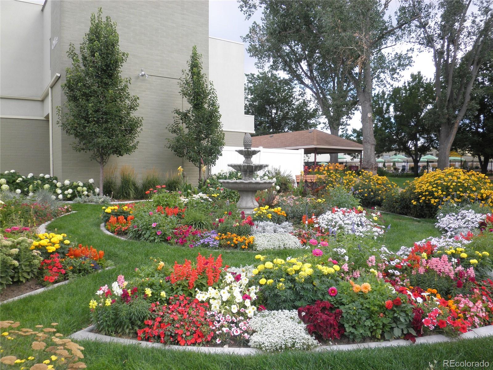9155 Center Avenue, Unit 9B Denver, CO 80247 - Photo 17 of 35 a bunch of flowers are in a garden