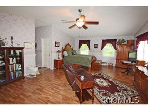 265 Hideaway Creek Road Clyde, NC 28721 - Photo 14 of 20 a living room with furniture and wooden floor