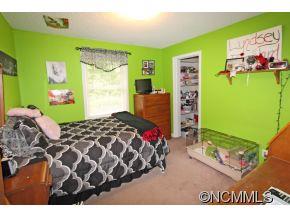265 Hideaway Creek Road Clyde, NC 28721 - Photo 18 of 20 a bedroom with a bed and a painting on the wall