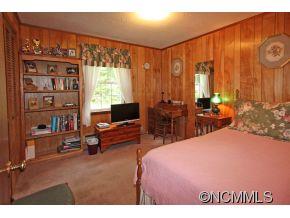 265 Hideaway Creek Road Clyde, NC 28721 - Photo 20 of 20 a bedroom with a bed a large window and book shelf