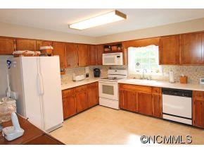 265 Hideaway Creek Road Clyde, NC 28721 - Photo 9 of 20 a kitchen with a sink a window and a refrigerator