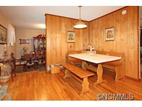 265 Hideaway Creek Road Clyde, NC 28721 - Photo 10 of 20 a view of a dining room with furniture and chandelier