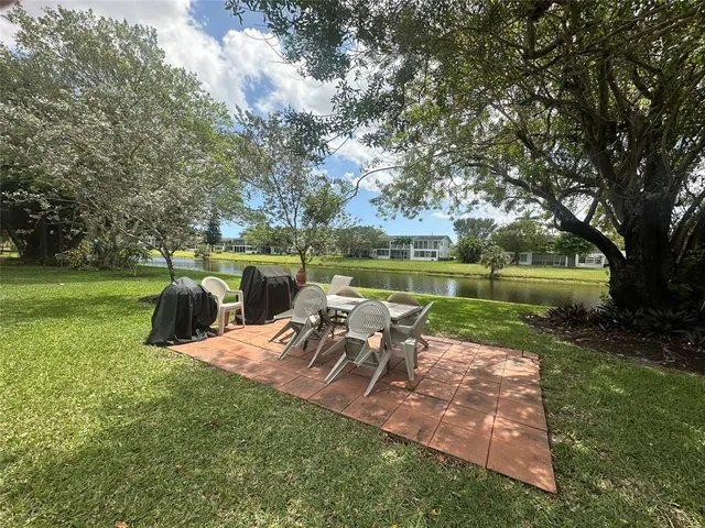 an aerial view of residential houses with outdoor space and river