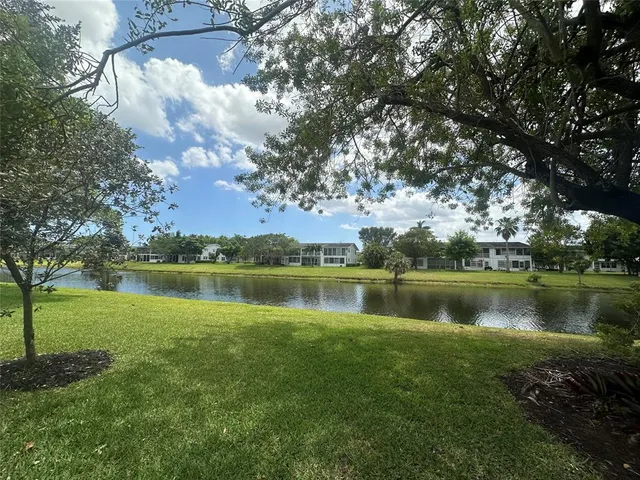 an aerial view of a house with swimming pool and garden
