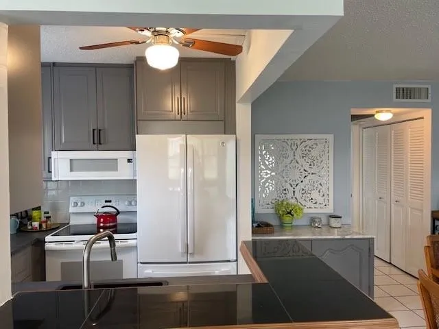 a kitchen with stainless steel appliances a sink stove and refrigerator