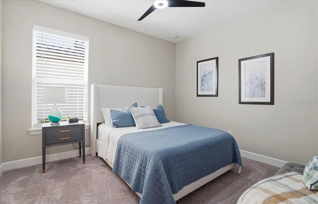 a spacious bedroom with a bed and a window