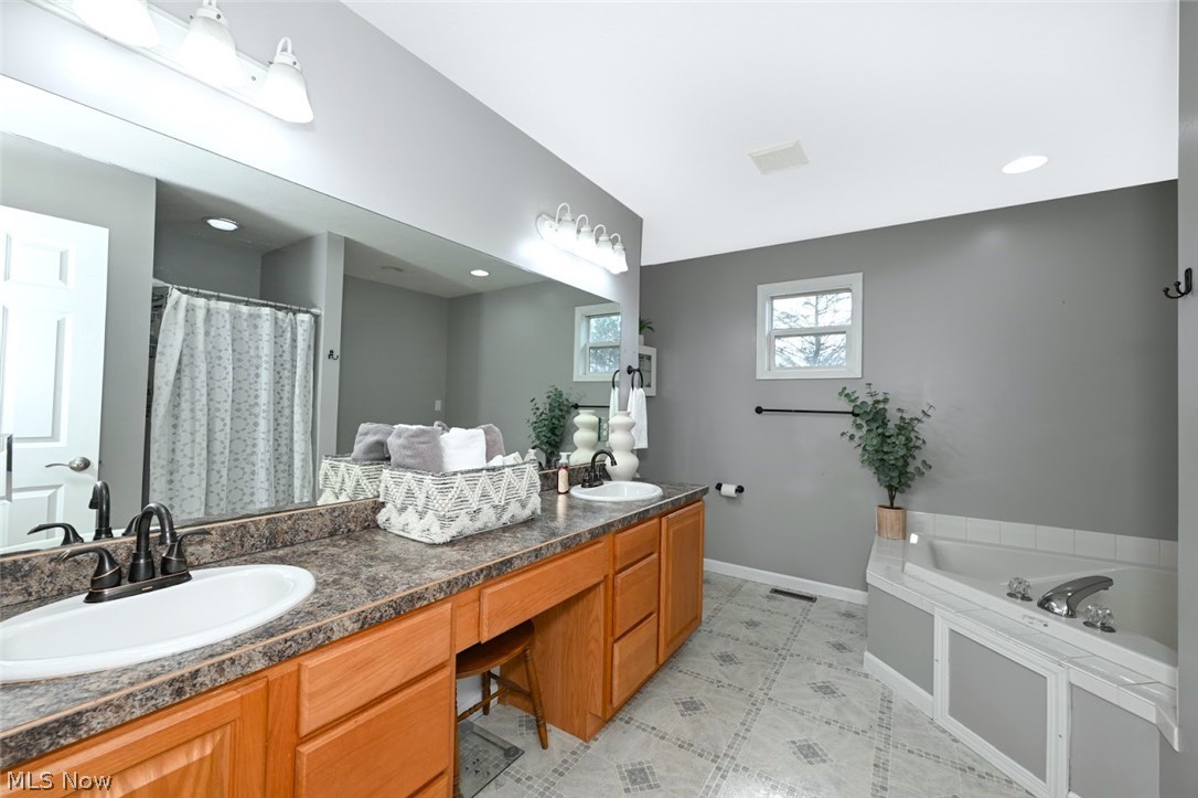 3880 Selnik Road Kent, OH 44240 - Photo 27 of 46 *ENSUITE MASTER BATHROOM W/LARGE VANITY INCLUDING AREA FOR STOOL SEATING, DOUBLE HIS & HER SINKS, MOEN FAUCETS, CORNER JETTED TUB & SEPARATE WALK IN SHOWER ~