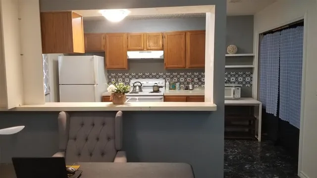 a kitchen with stainless steel appliances a stove a sink and a refrigerator