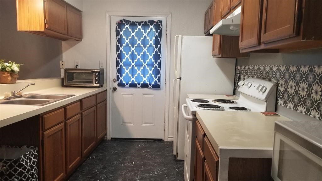 23393 Nameless Road, Unit 145 Leander, TX 78641 - Photo 6 of 16 a kitchen with stainless steel appliances a stove a sink and a refrigerator