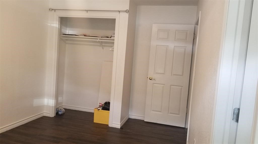 23393 Nameless Road, Unit 145 Leander, TX 78641 - Photo 9 of 16 a view of an empty room with wooden floor