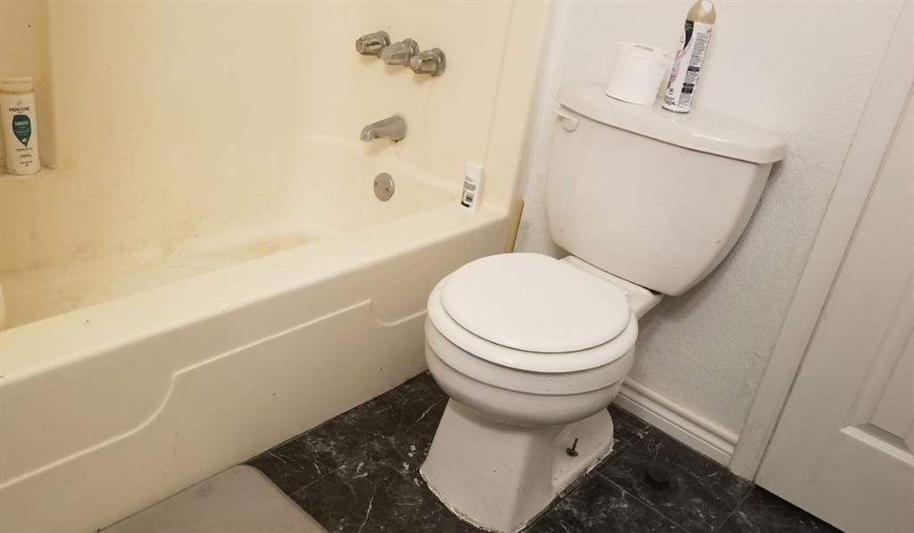 23393 Nameless Road, Unit 145 Leander, TX 78641 - Photo 10 of 16 a bathroom with a toilet and a shower