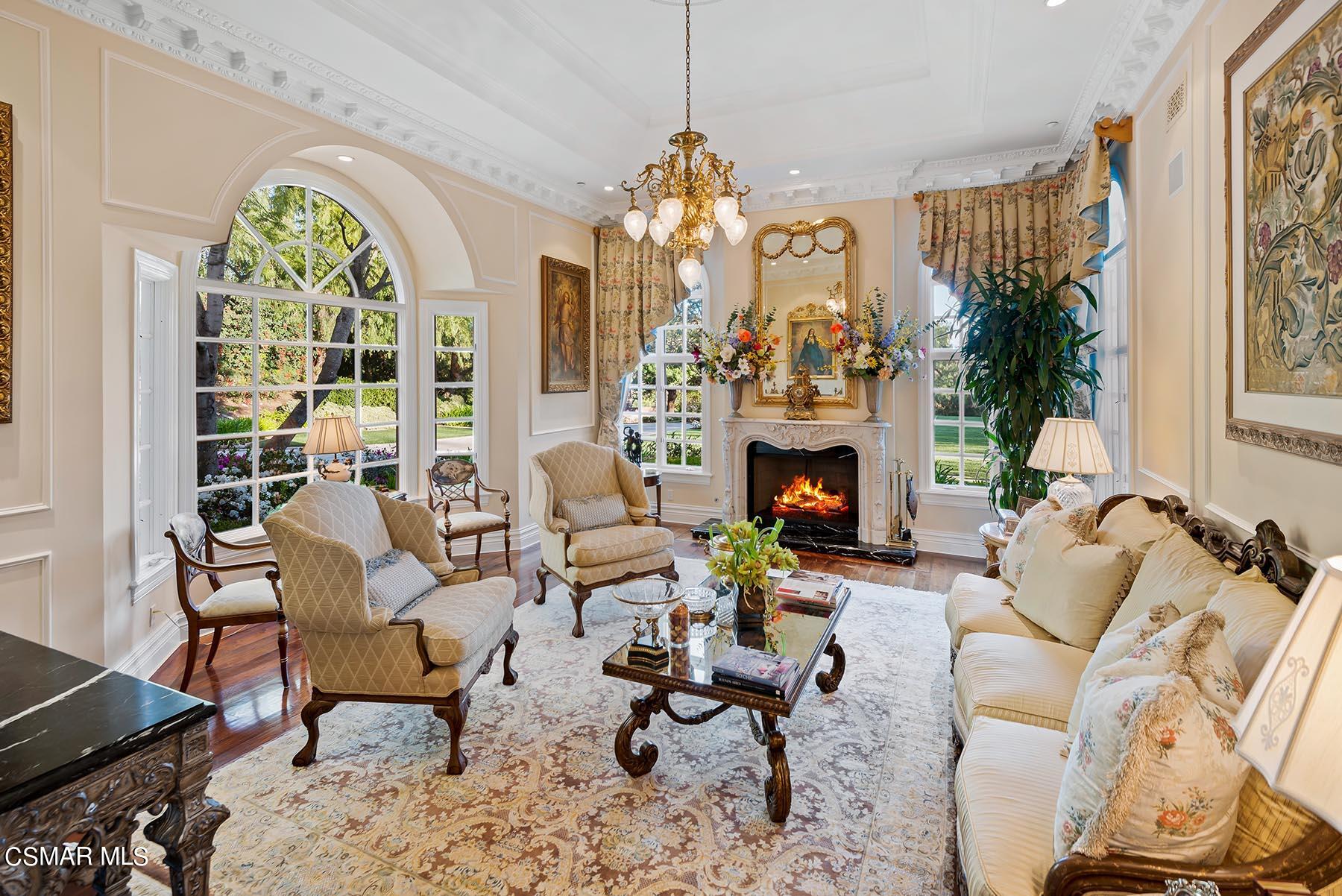 2155 Upper Ranch Road Westlake Village, CA 91362 - Photo 17 of 52 a living room with furniture a chandelier and a fireplace
