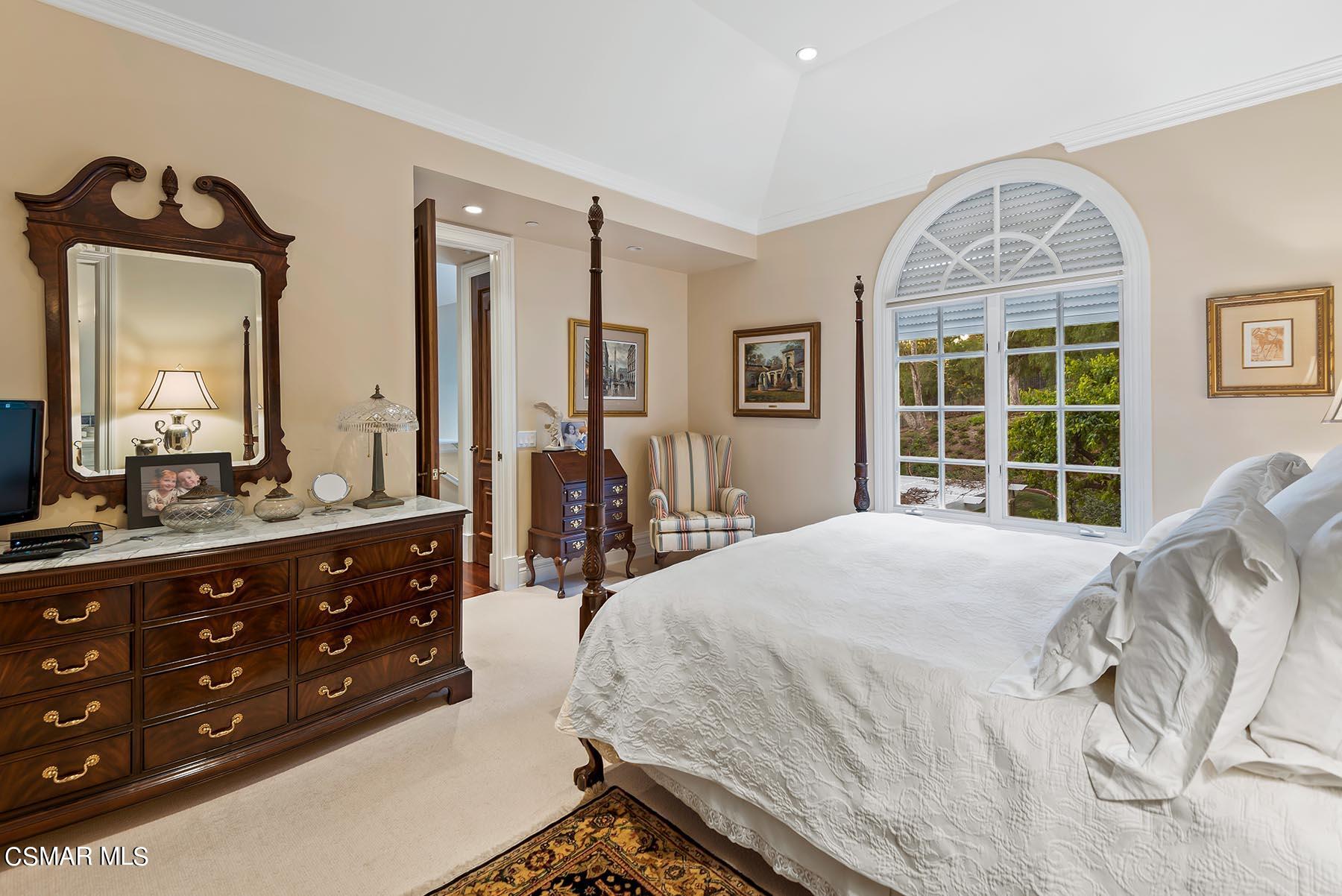 2155 Upper Ranch Road Westlake Village, CA 91362 - Photo 44 of 52 a spacious bedroom with a bed a dresser a mirror and a large window