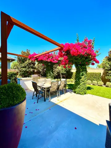 a view of a patio with table and chairs and potted plants