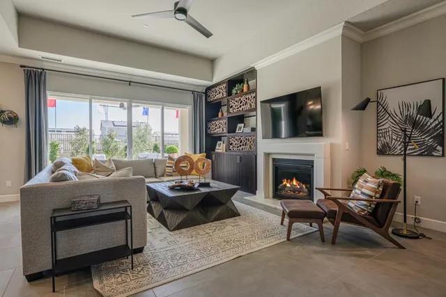 a living room with furniture a fireplace and a flat screen tv