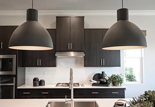 a kitchen with a sink a stove and lots of cabinets