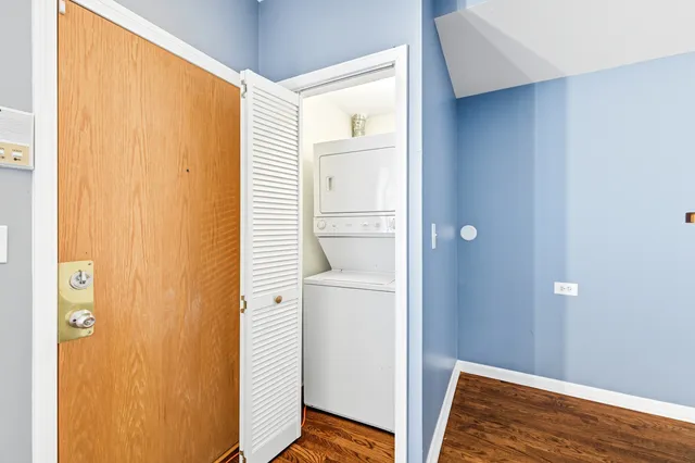 a kitchen with granite countertop a refrigerator and a stove top oven