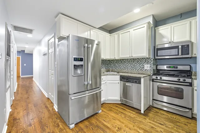 a kitchen with a refrigerator and a sink