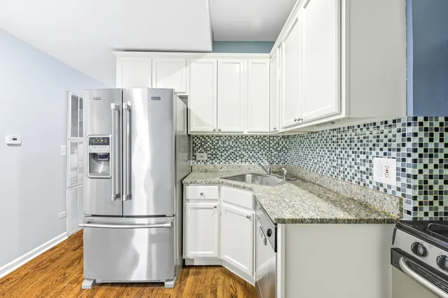 a kitchen with stainless steel appliances a refrigerator stove and sink