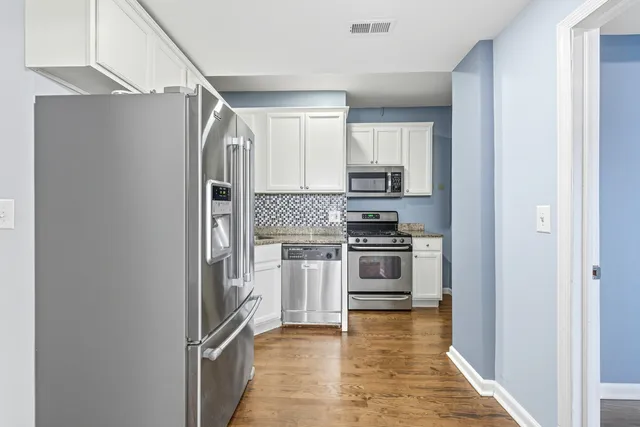 a bathroom with a toilet a sink and a large mirror