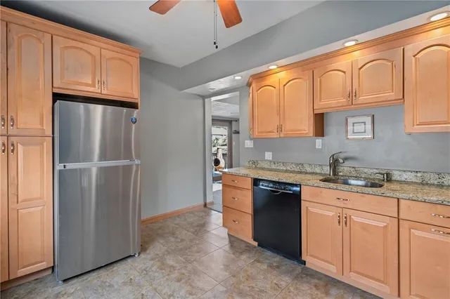 a kitchen with stainless steel appliances granite countertop a refrigerator and sink