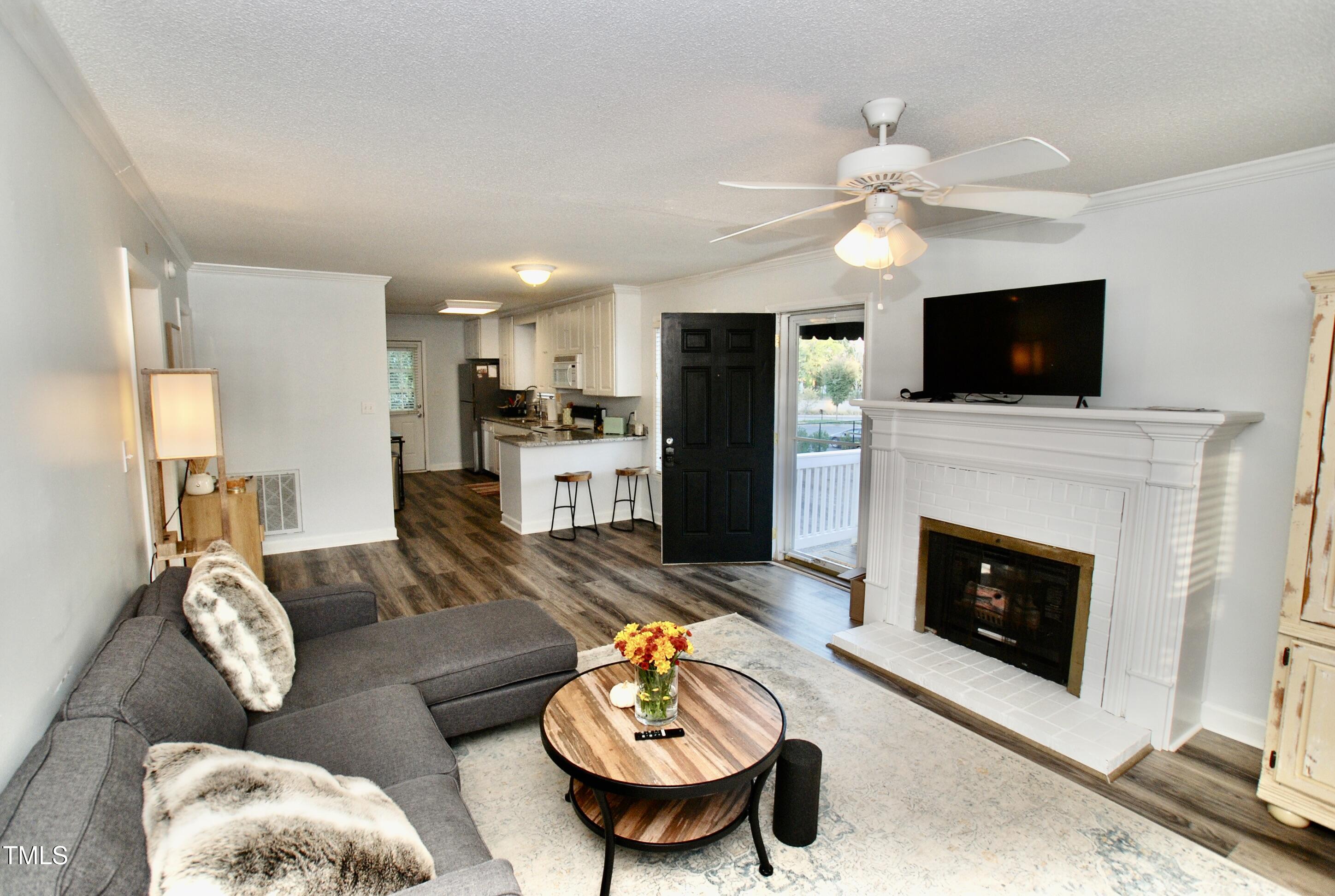 2306 Stafford Avenue, Unit B Raleigh, NC 27607 - Photo 4 of 29 a living room with furniture a flat screen tv and a fireplace