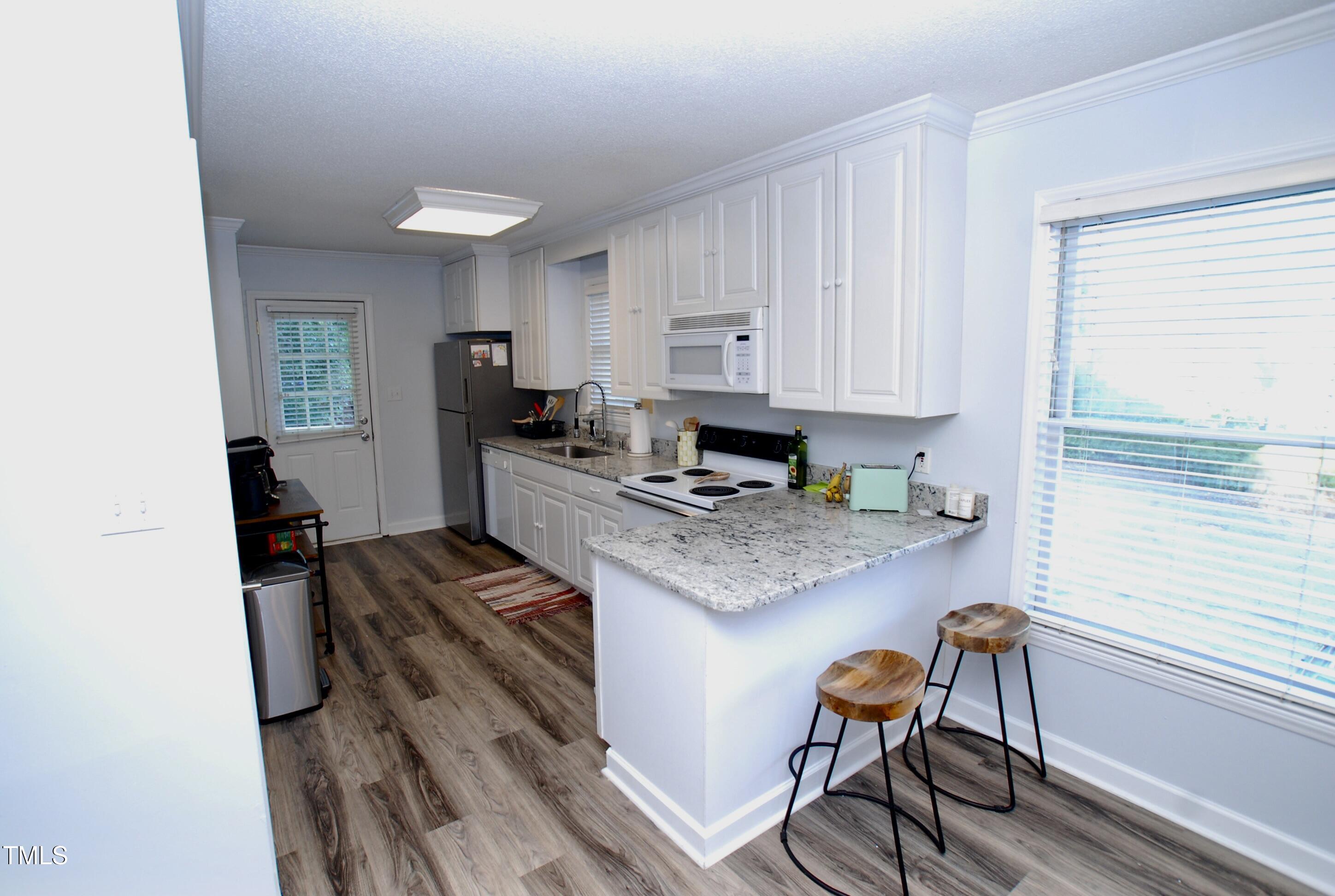2306 Stafford Avenue, Unit B Raleigh, NC 27607 - Photo 7 of 29 a kitchen with a stove and a refrigerator