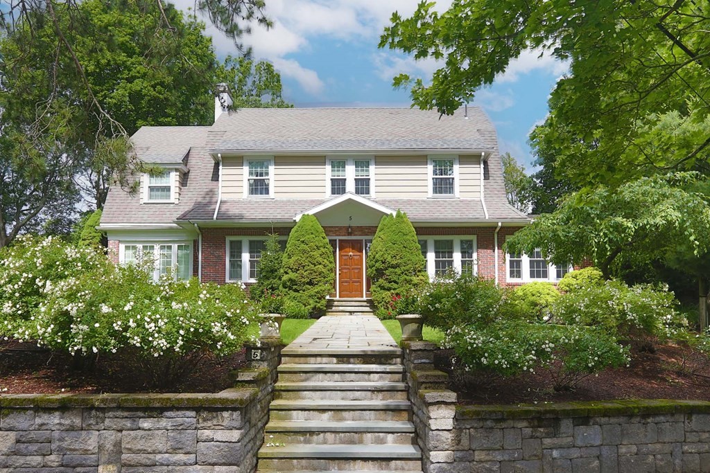 a front view of a house with garden