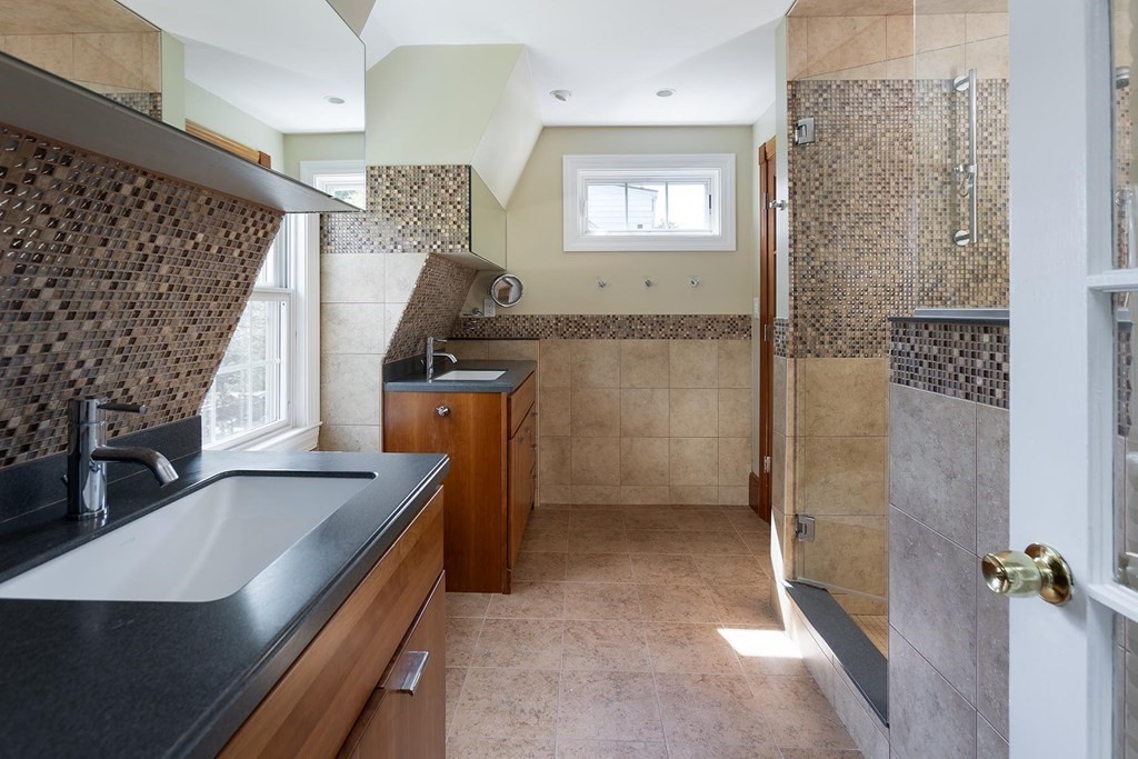 5 Agawam Road Newton, MA 02468 - Photo 16 of 23 a bathroom with a sink a mirror and shower