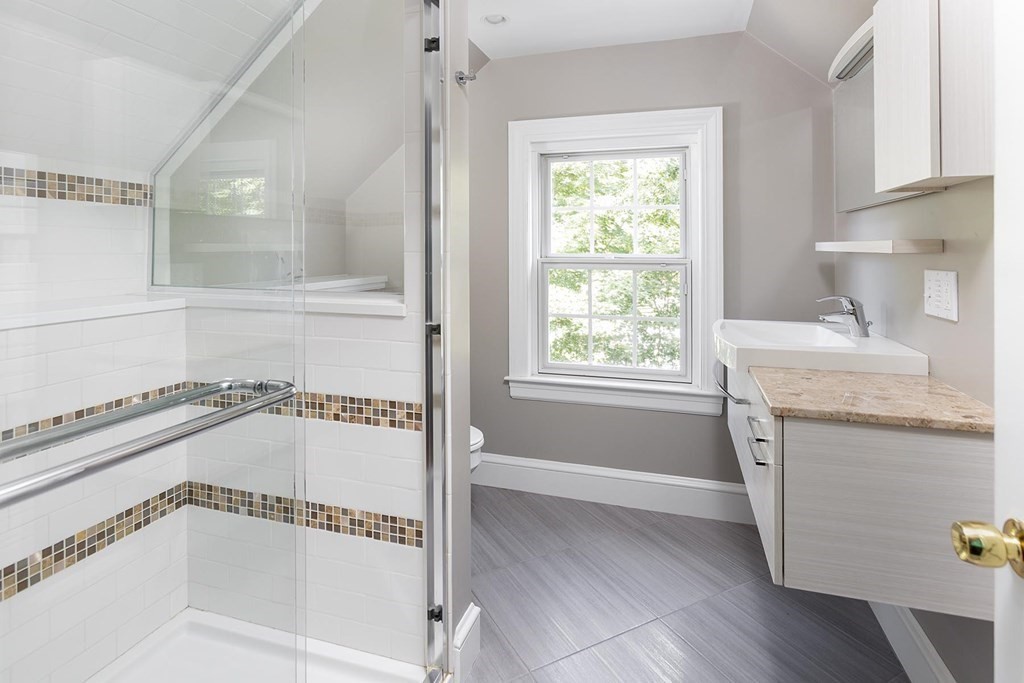 5 Agawam Road Newton, MA 02468 - Photo 18 of 23 a bathroom with a granite countertop sink mirror and a bathtub