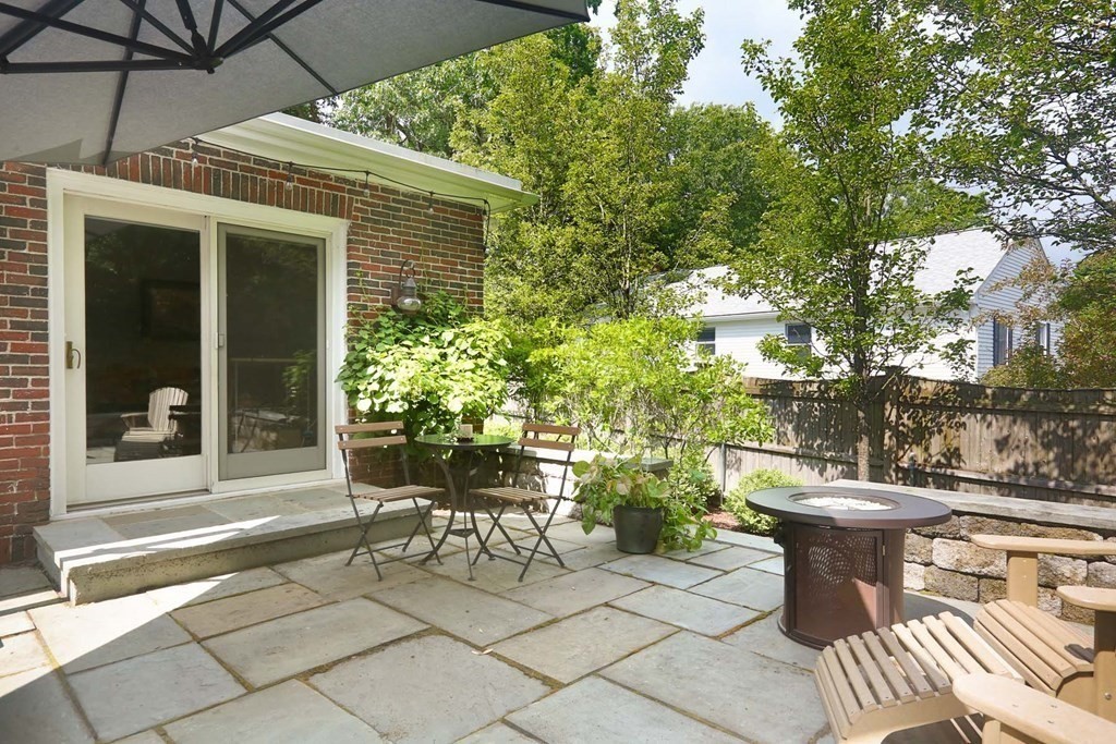 5 Agawam Road Newton, MA 02468 - Photo 19 of 23 a view of a patio with table and chairs and potted plants