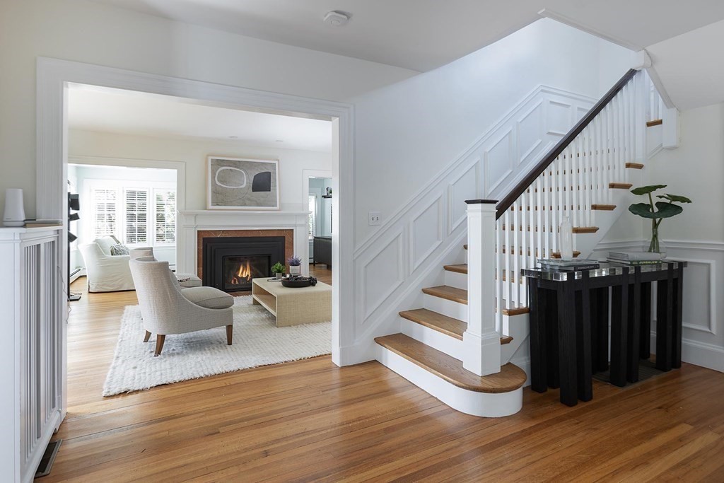 5 Agawam Road Newton, MA 02468 - Photo 2 of 23 a living room with wooden floors and a fireplace