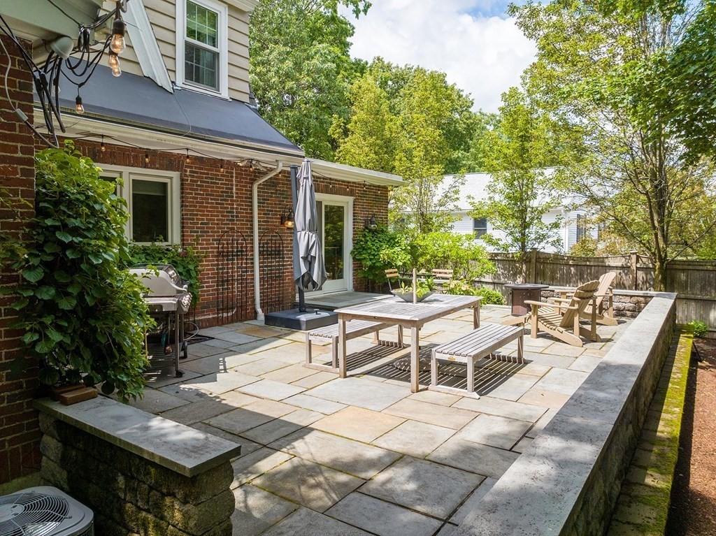 5 Agawam Road Newton, MA 02468 - Photo 23 of 23 a view of a patio with table and chairs and potted plants