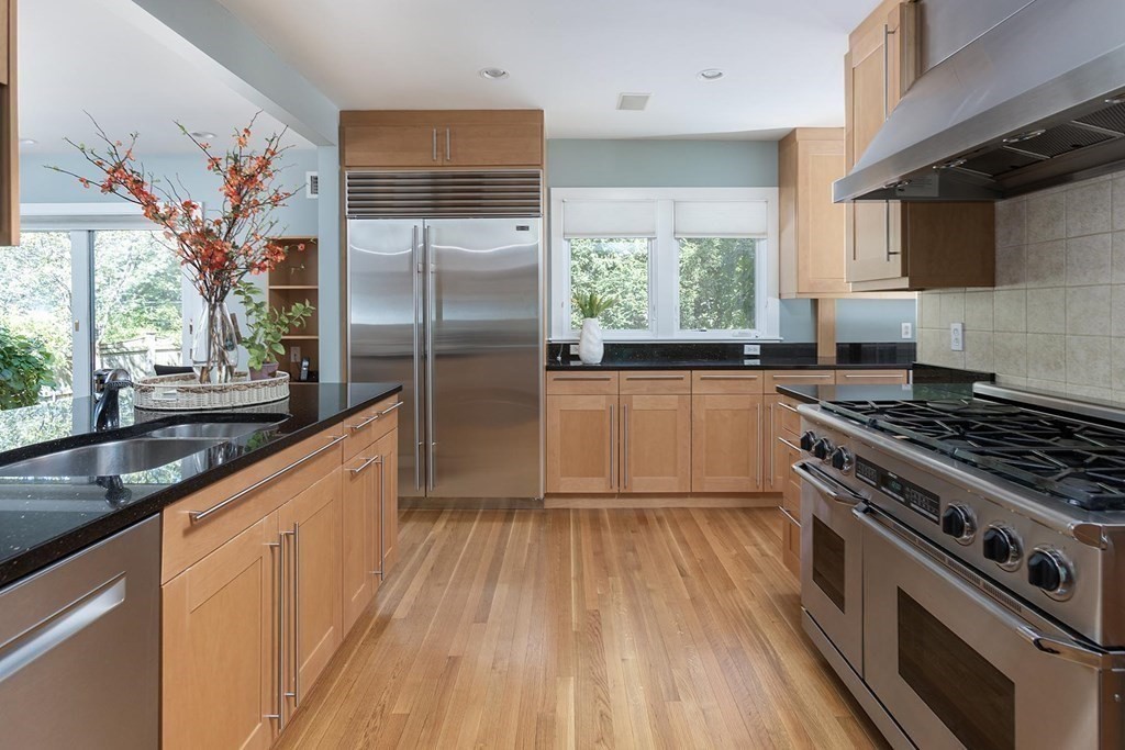 5 Agawam Road Newton, MA 02468 - Photo 9 of 23 a kitchen with stainless steel appliances granite countertop a stove a sink and a refrigerator
