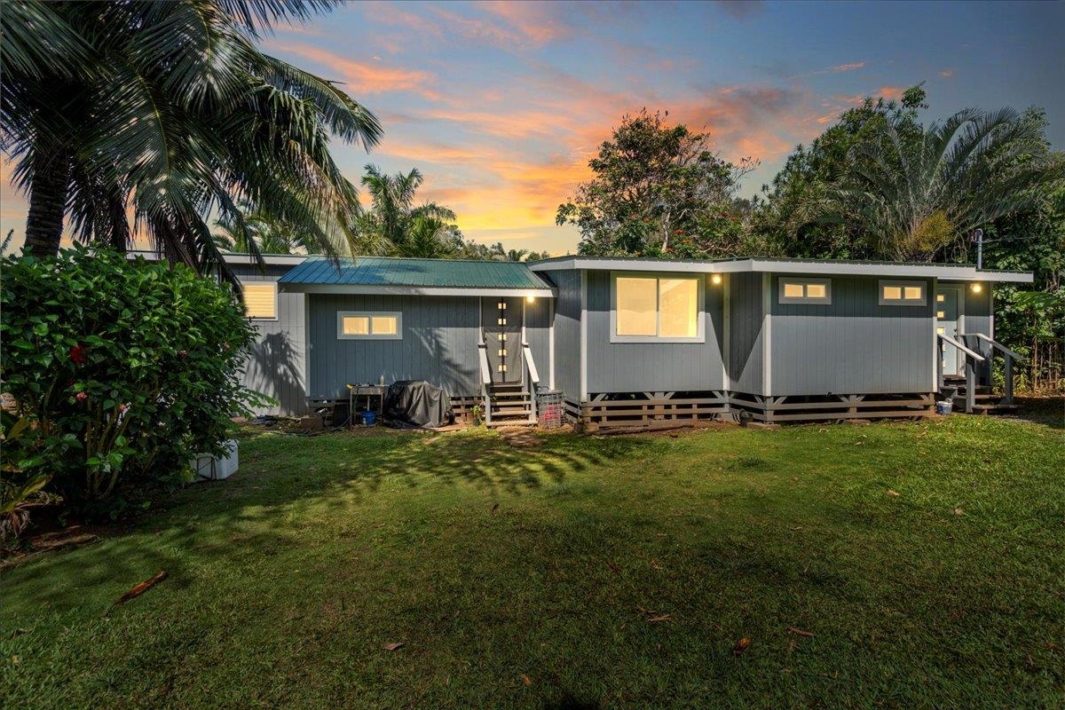 a front view of house with yard and outdoor seating