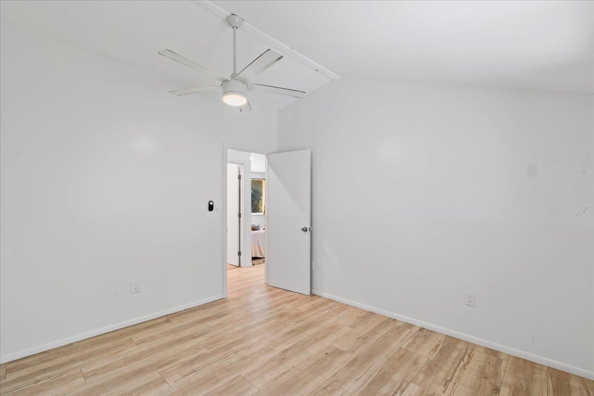 265 Hahana Road Haiku, HI 96708 - Photo 11 of 48 an empty room with wooden floor and ceiling fan