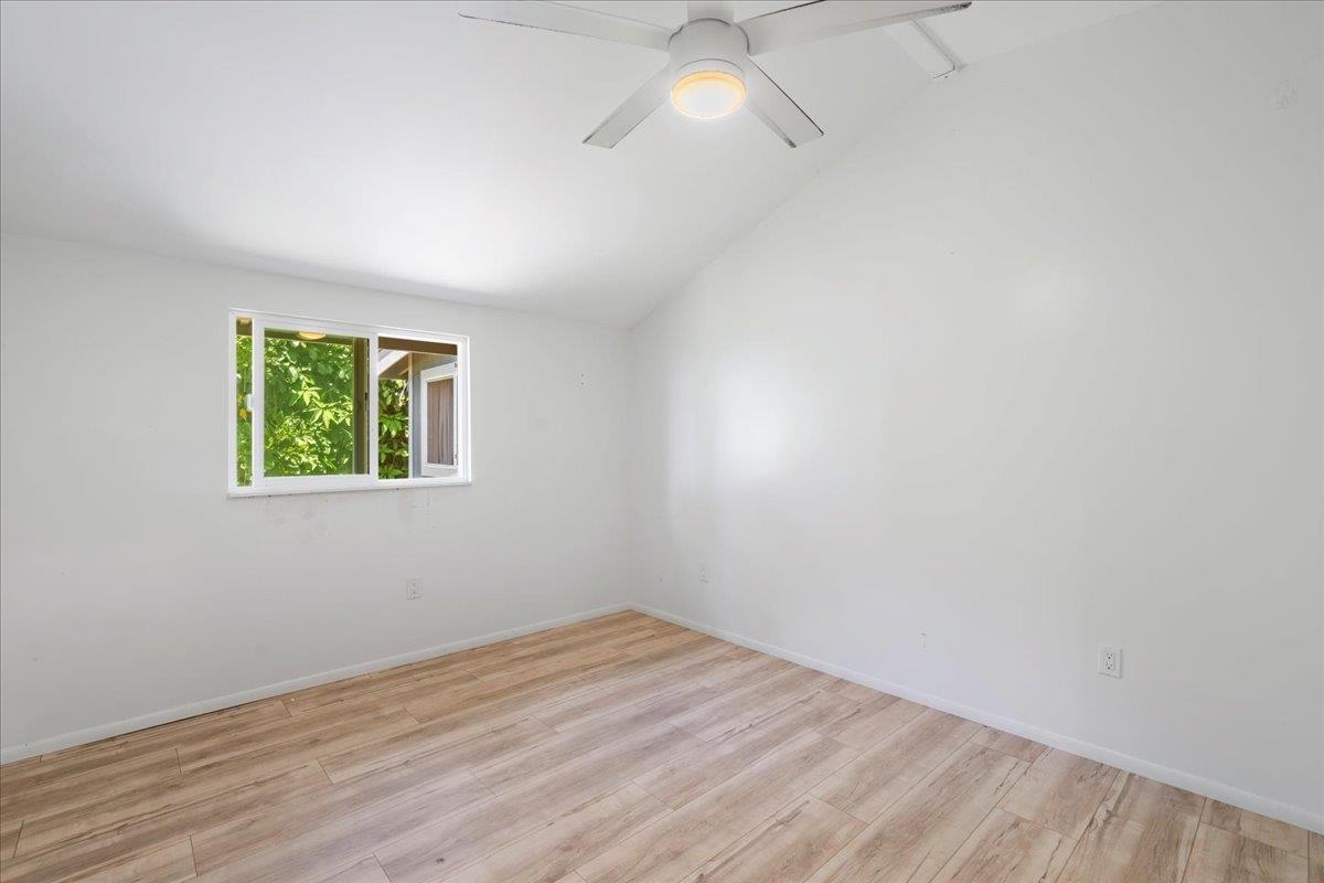 265 Hahana Road Haiku, HI 96708 - Photo 12 of 48 an empty room with a window and wooden floor