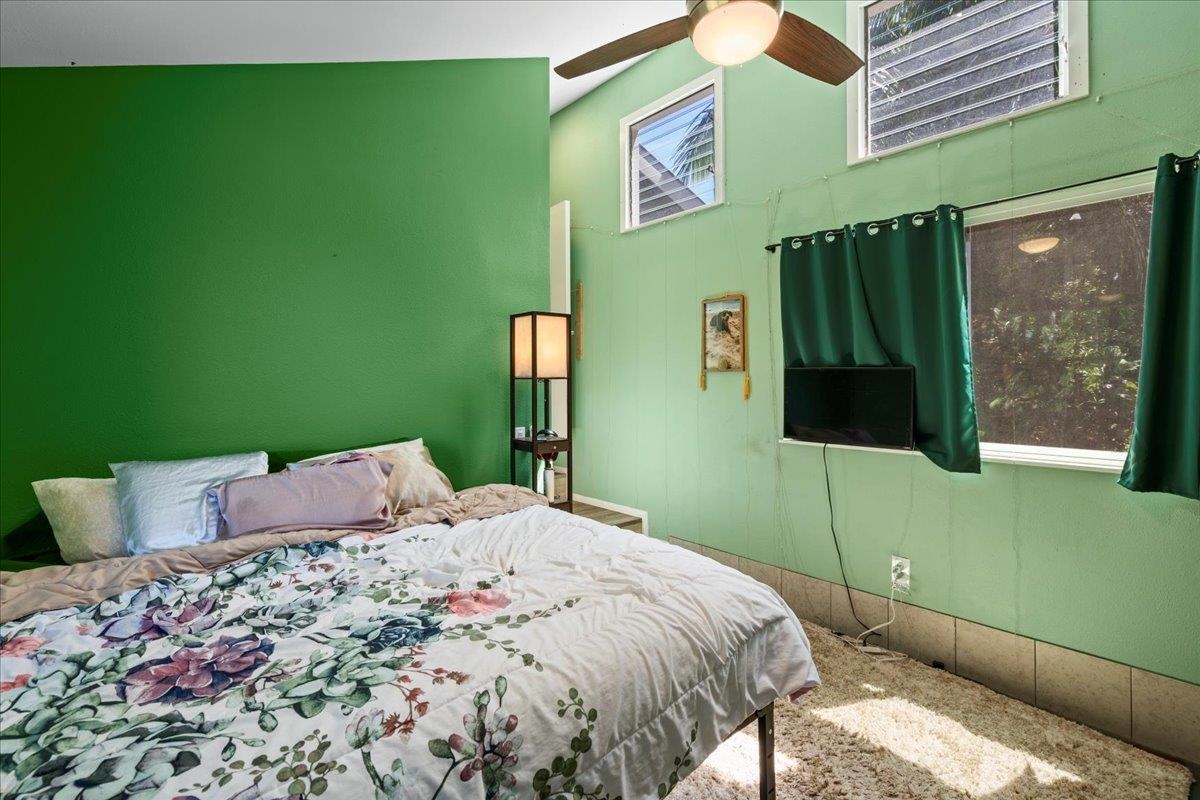 265 Hahana Road Haiku, HI 96708 - Photo 19 of 48 a bedroom with a bed and a television