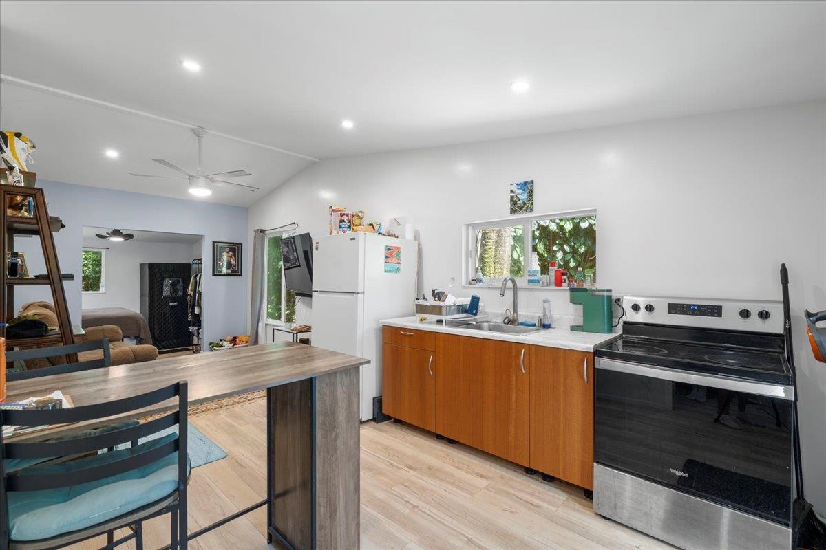 265 Hahana Road Haiku, HI 96708 - Photo 21 of 48 a kitchen with stainless steel appliances kitchen island granite countertop a stove and a sink